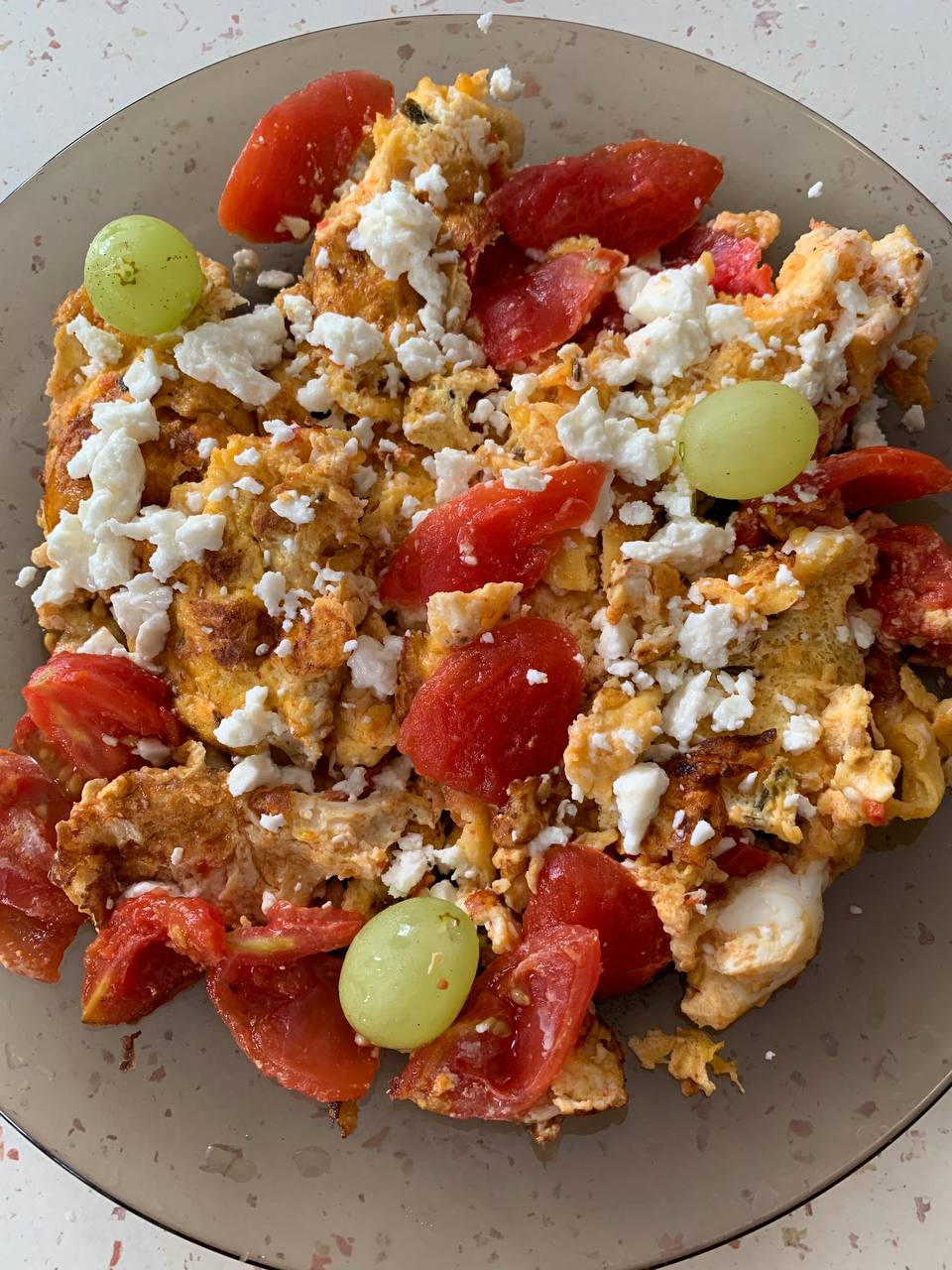 Scrambled Eggs With Tomato, Crumbled Cheese, And Olives