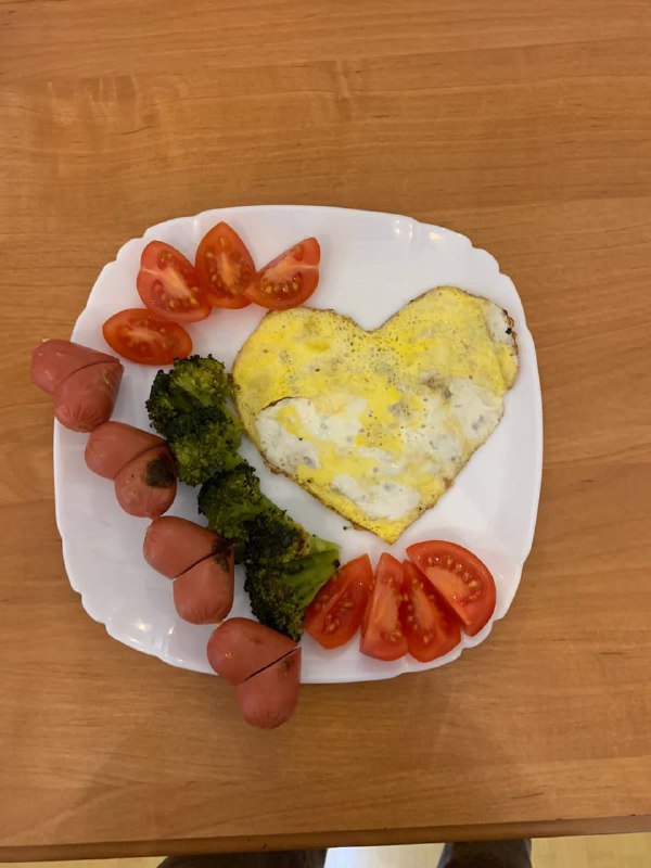 Breakfast Plate Featuring An Omelet, Sausages, Broccoli, And Cherry Tomatoes