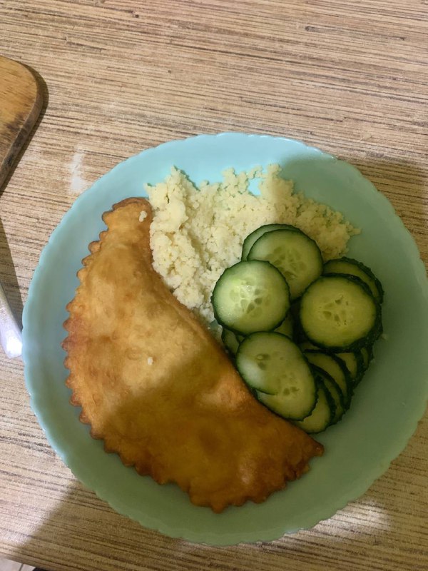 Cheburek With Couscous And Sliced Cucumbers
