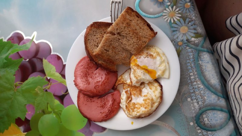 Breakfast Plate With Fried Eggs, Sausage, And Whole Wheat Bread