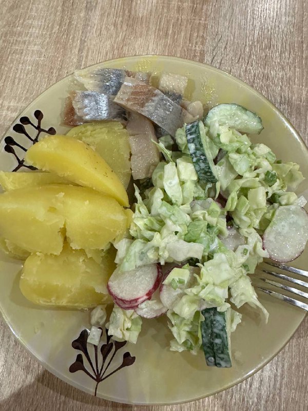 Homemade Meal With Boiled Potatoes, Pickled Herring, And Fresh Vegetable Salad