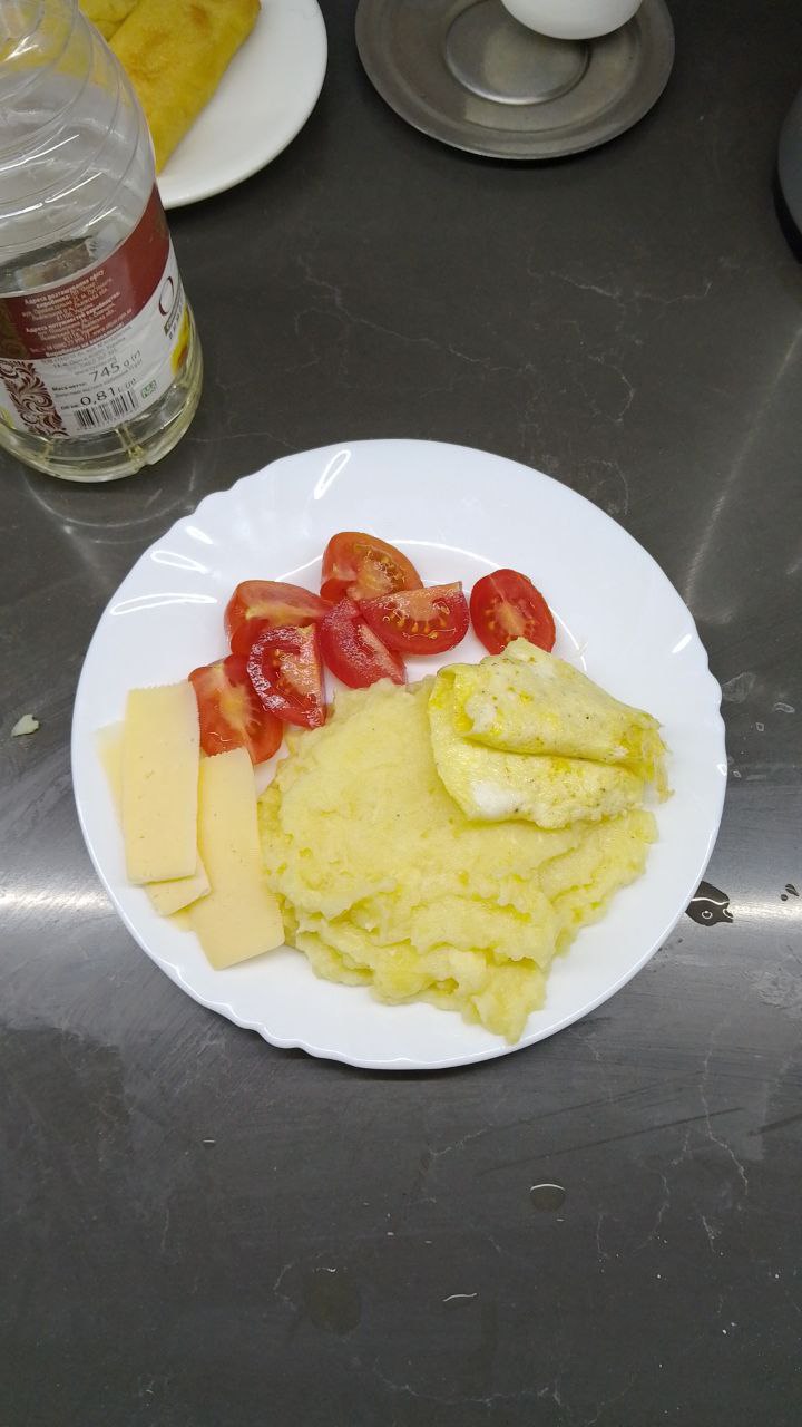 Scrambled Eggs With Mashed Potatoes, Cheese Slices, And Fresh Tomato Slices