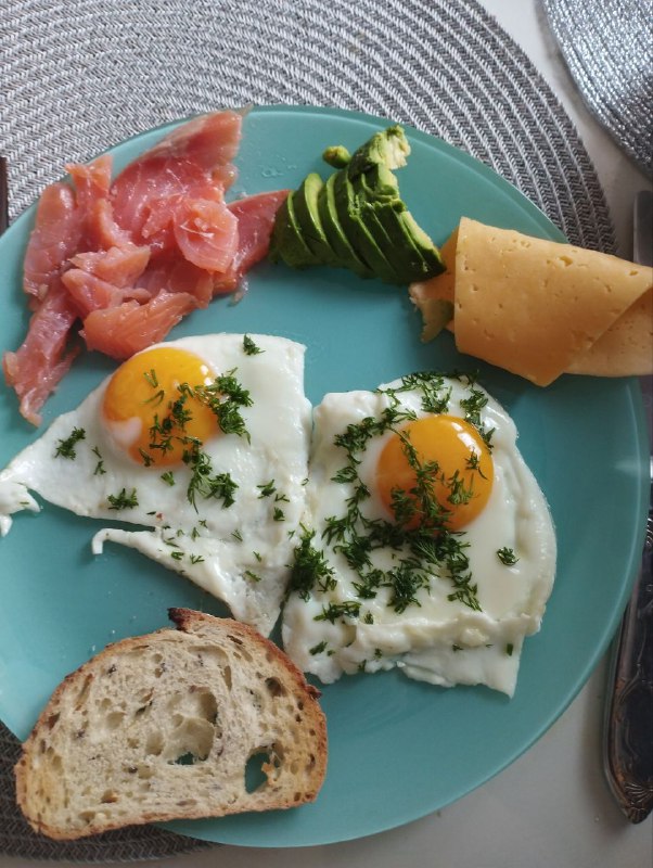 Breakfast Plate With Fried Eggs, Smoked Salmon, Avocado, Cheese, And Bread