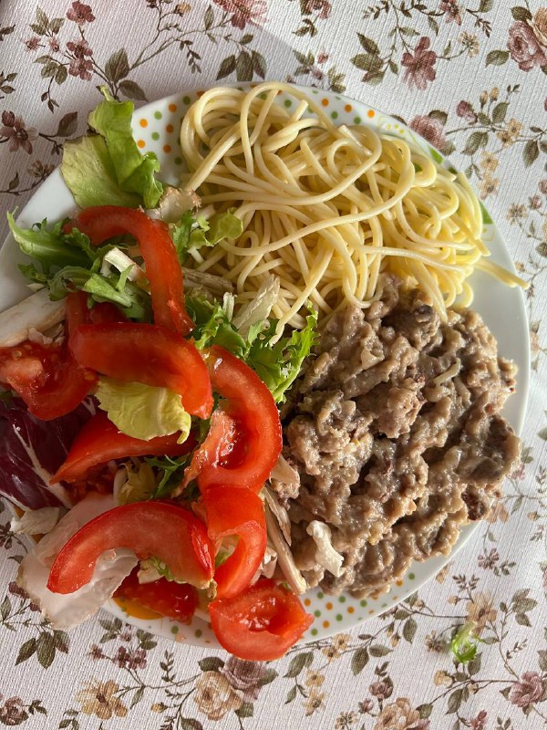 Homemade Plate With Spaghetti, Stewed Chicken Liver With Onions And Cream, And A Side Salad