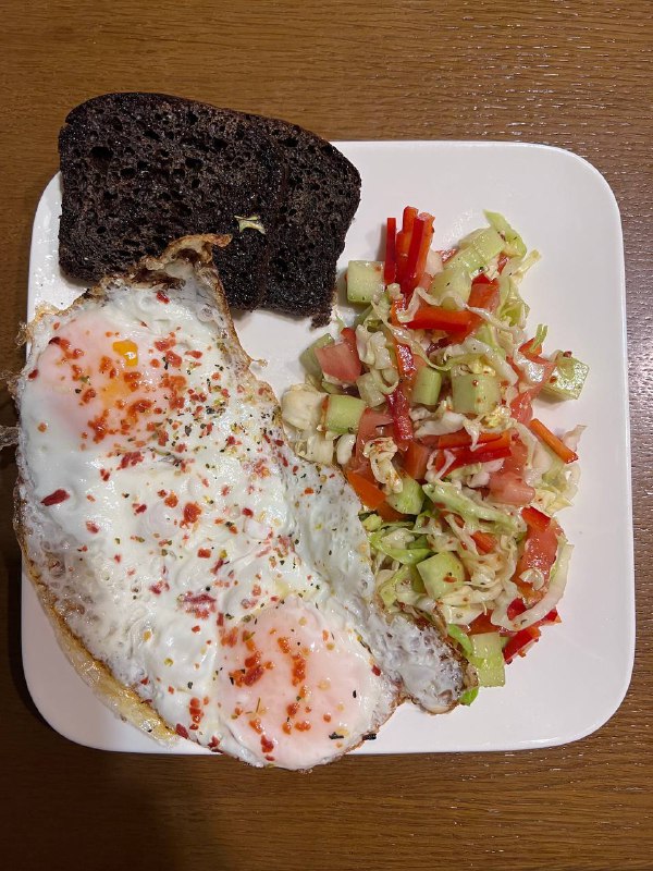 Fried Eggs On Toast With Salad And Dark Rye Bread