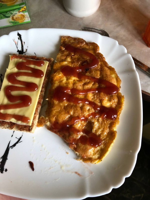 Omelette On Toast With Ketchup And Mayo
