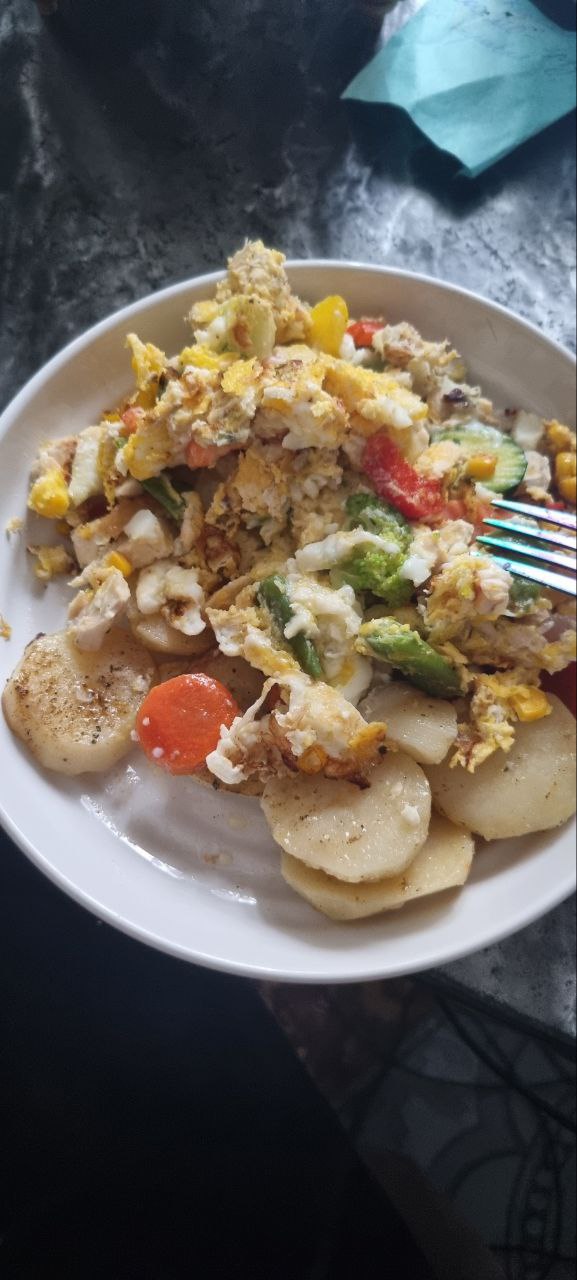 Scrambled Eggs With Sautéed Vegetables And Sliced Potatoes
