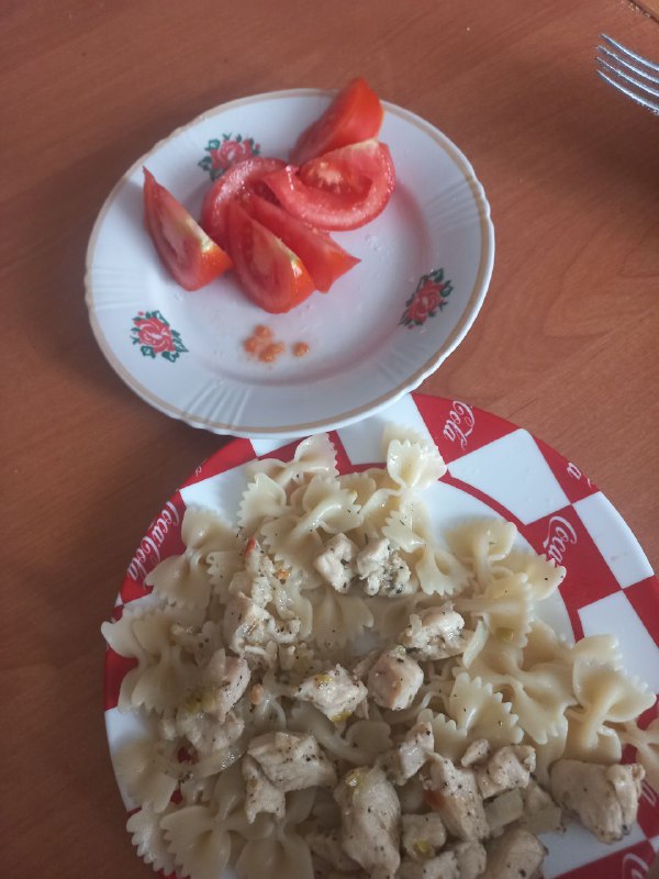 Chicken Pasta With A Side Of Fresh Tomato Slices