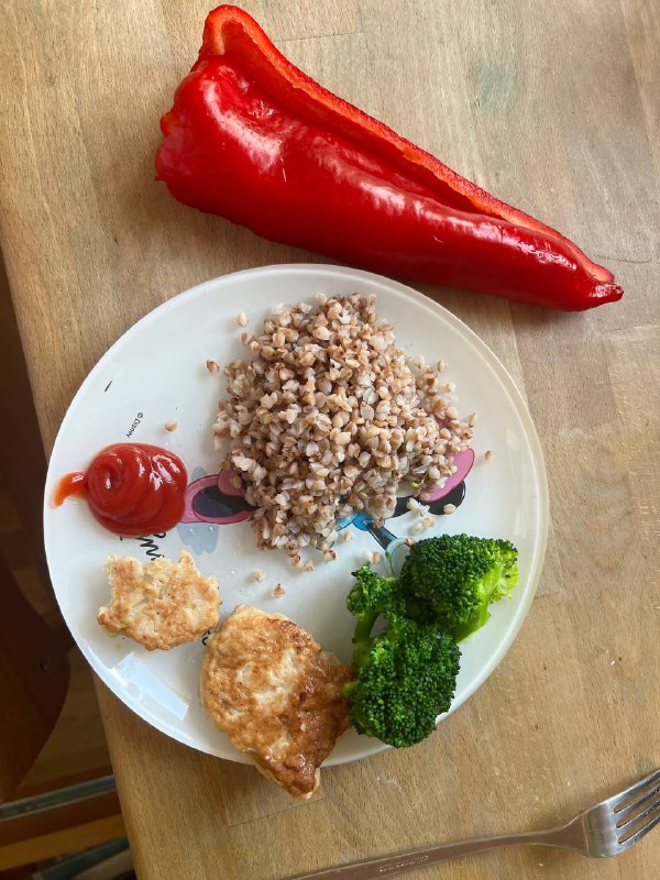 Homemade Meal With Buckwheat, Chicken Nuggets, Steamed Broccoli, Ketchup, And Red Bell Pepper