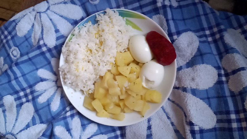 Simple Meal With White Rice, Boiled Potatoes, Boiled Eggs, And Sausage Or Salami Slice