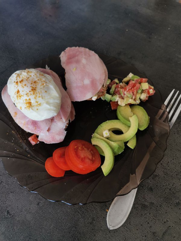 Eggs Benedict With A Side Of Avocado And Tomato Salad