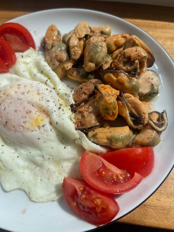 Seafood Medley With A Fried Egg And Tomatoes