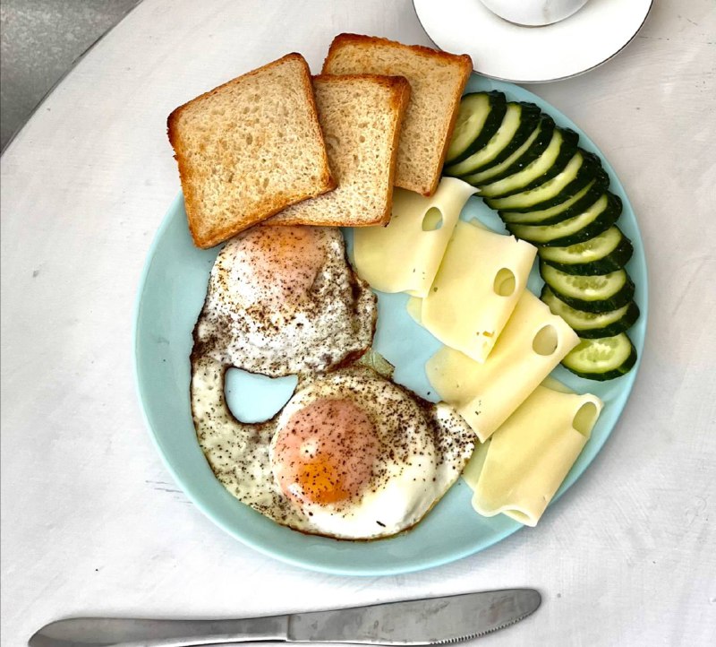 Fried Eggs With Toast, Cheese, And Cucumber Slices
