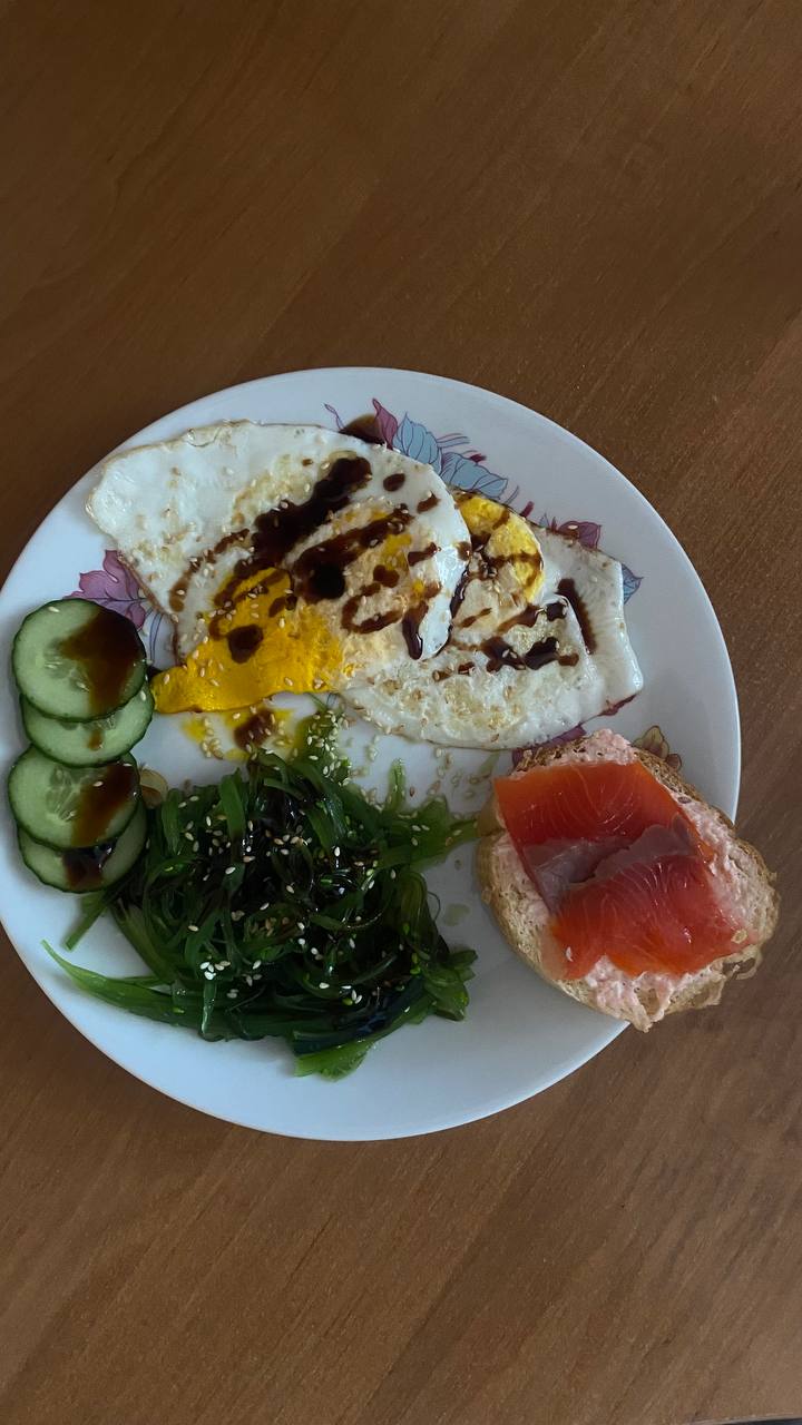 Smoked Salmon Bagel With Fried Eggs, Seaweed Salad, And Cucumber