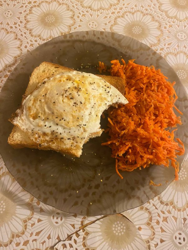 Fried Egg On Toast With Shredded Carrots