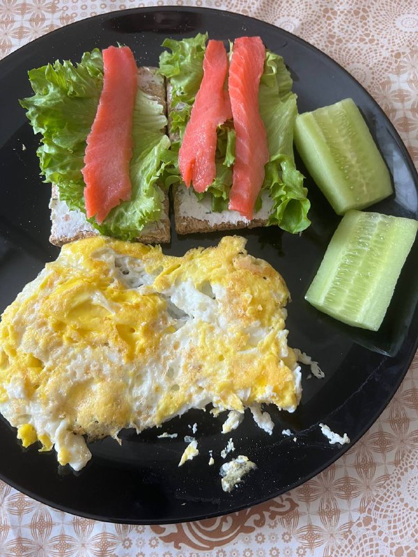 Smoked Salmon Open-Faced Sandwich with a Side of Scrambled Eggs and Cucumber Slices