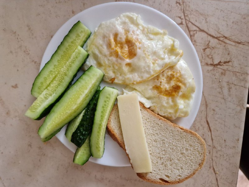 Fried Eggs With Bread, Cheese, And Cucumber Slices