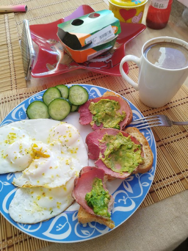 Open-faced Sandwich With Avocado And Pastrami, Fried Eggs, Sliced Cucumber