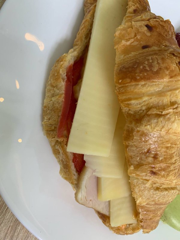 Croissant Sandwich With Cheese, Ham, And Tomato