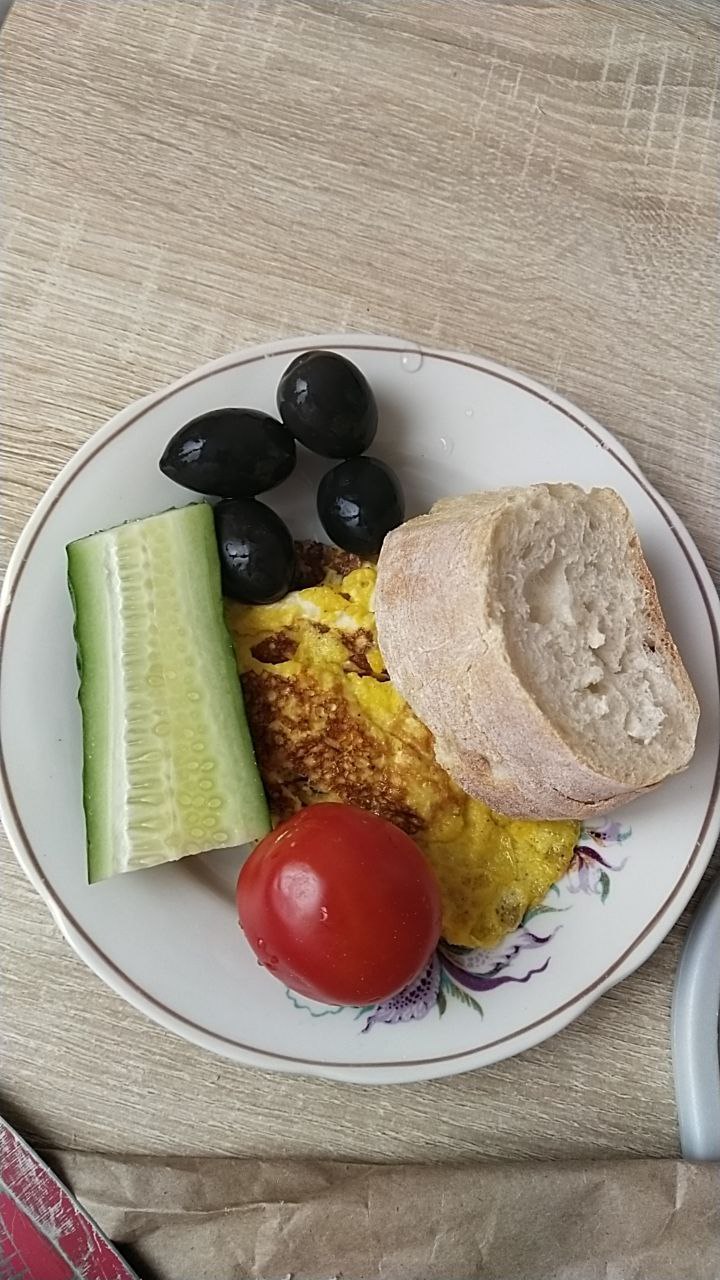 Breakfast Plate With Omelette, Bread, Vegetables, And Olives