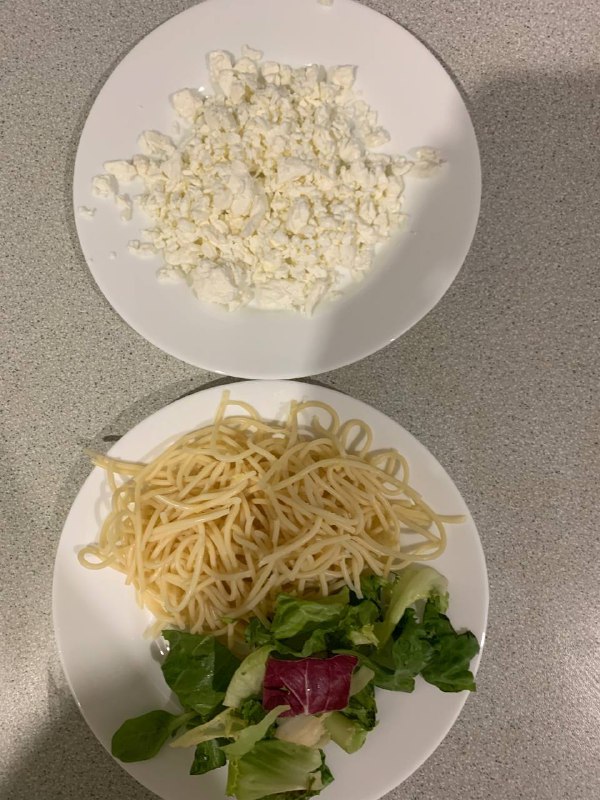 Spaghetti With Side Salad And Crumbled Cheese