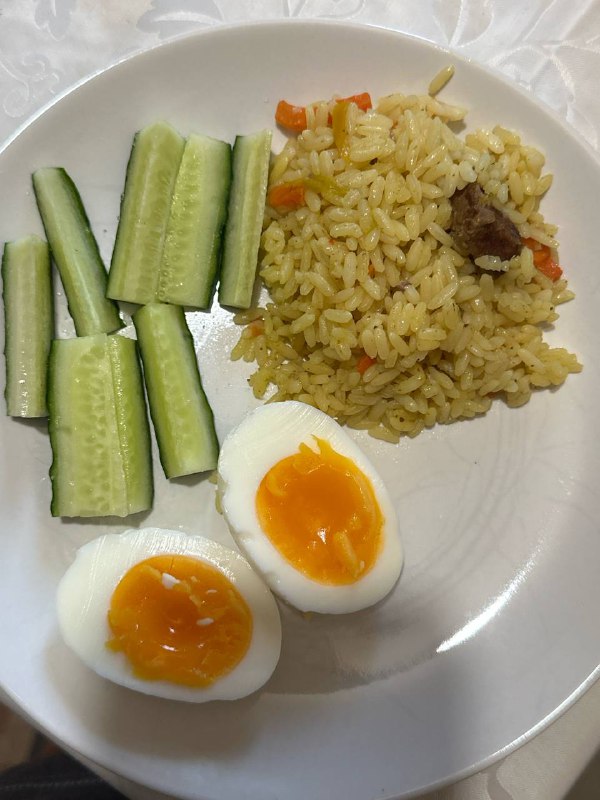 Fried Rice With Sliced Cucumbers And A Boiled Egg