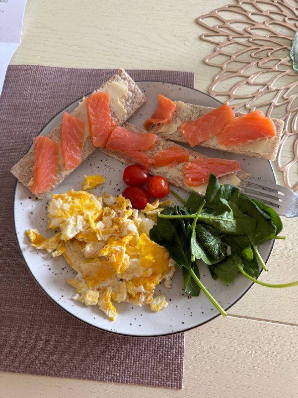 Scrambled Eggs With Smoked Salmon And Toast, Served With Spinach And Cherry Tomatoes