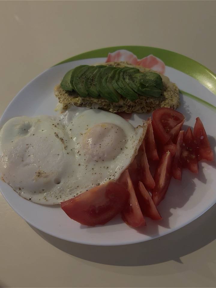 Avocado Toast With A Fried Egg And Tomato Slices