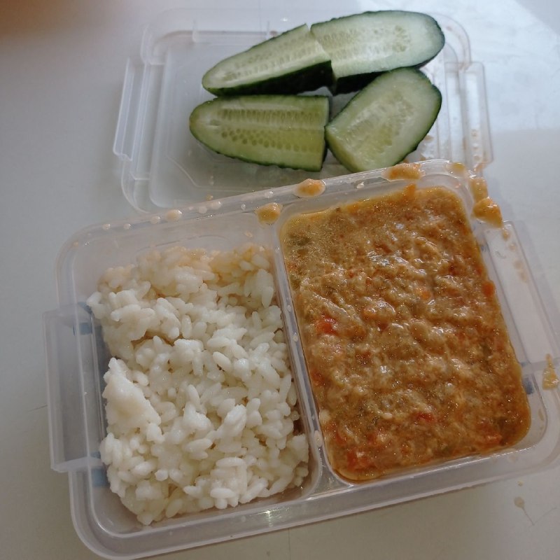 Homemade Meal With White Rice, Cucumber Slices, And Sauce