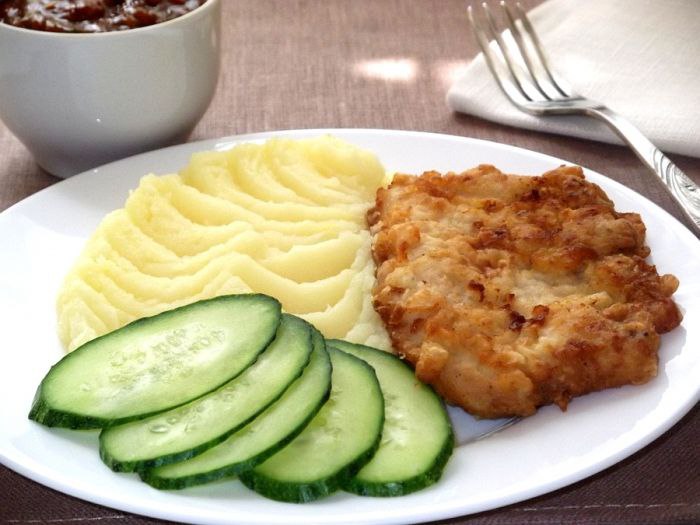 Breaded Chicken Cutlet With Mashed Potatoes And Sliced Cucumber