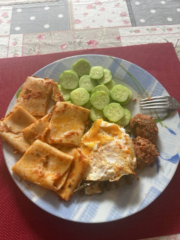 Cheese Ravioli With Fried Egg, Meatballs, And Sliced Cucumber