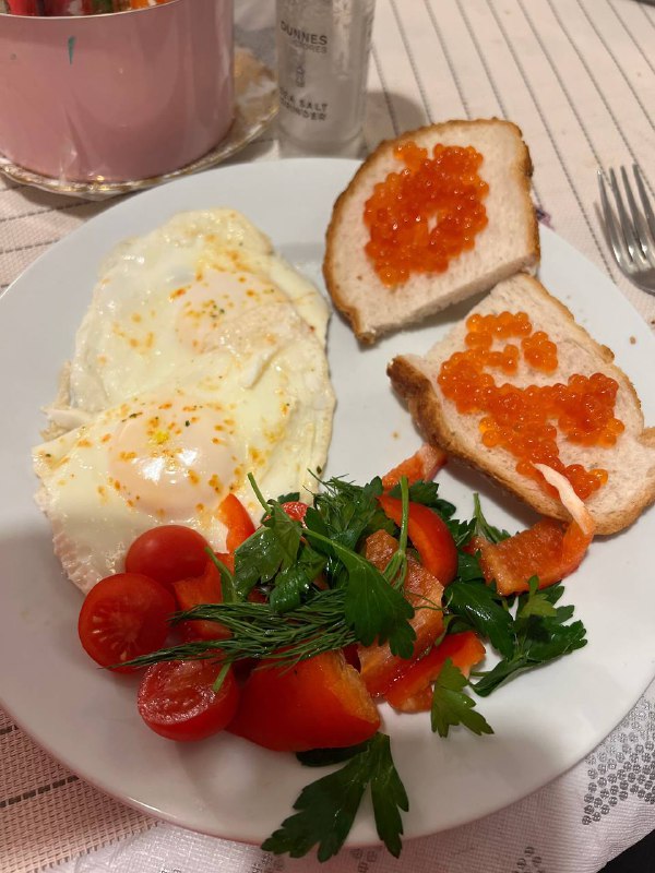 Fried Eggs With Caviar On Toast And Salad