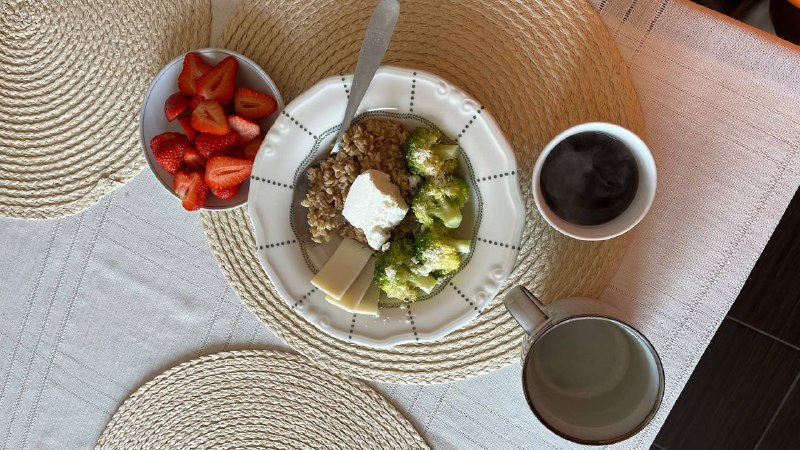 Mixed Plate With Strawberries, Rice, Broccoli, Cheese, And Coffee