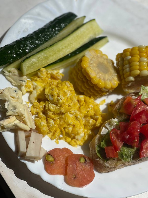 Mixed Platter With Scrambled Eggs, Vegetables, And Bread With Avocado And Tomato