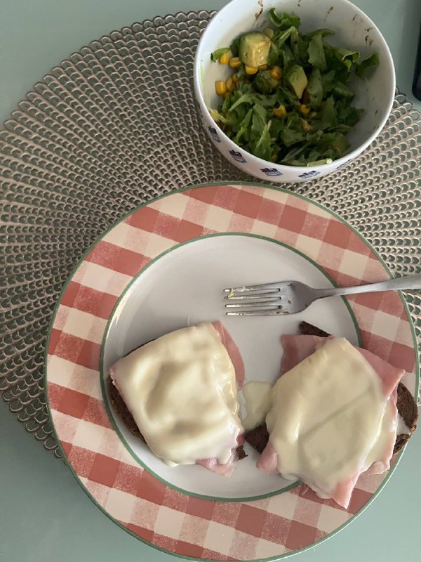 Open-faced ham and cheese sandwich with a side salad