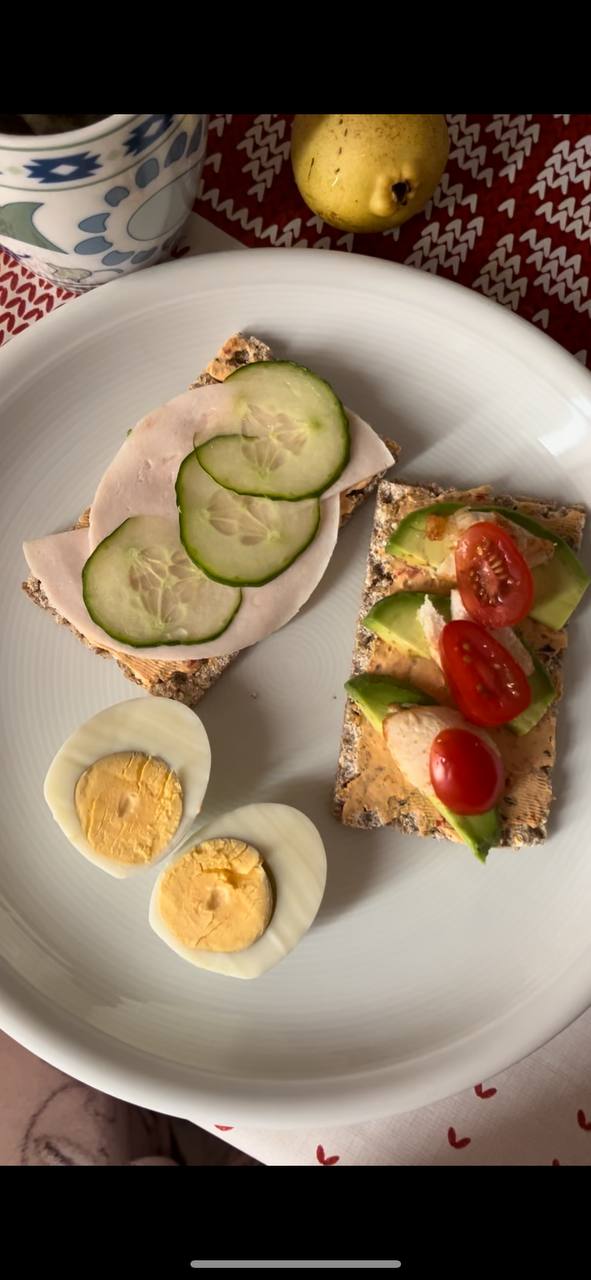 Open-faced Sandwiches With Boiled Eggs And Chicken Beneath Avocado